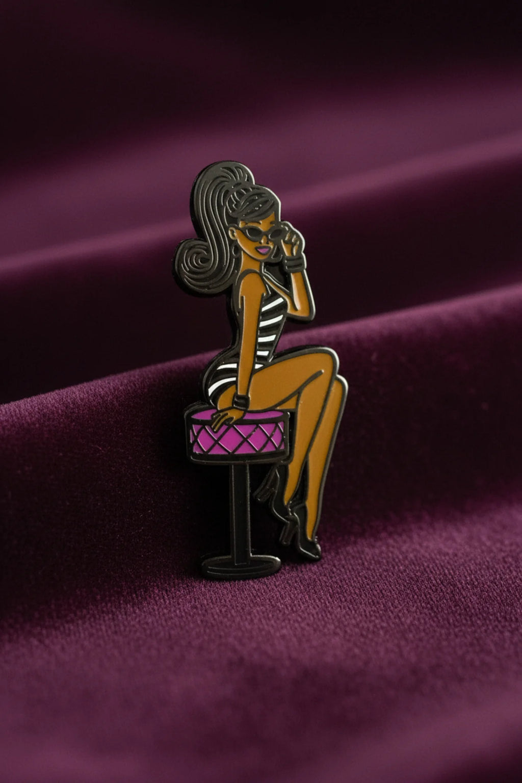 Shop our 1-inch minimalist Black doll pin with sunglasses. Premium enamel lapel pin featuring a rubber clutch. Elevate your everyday style today.