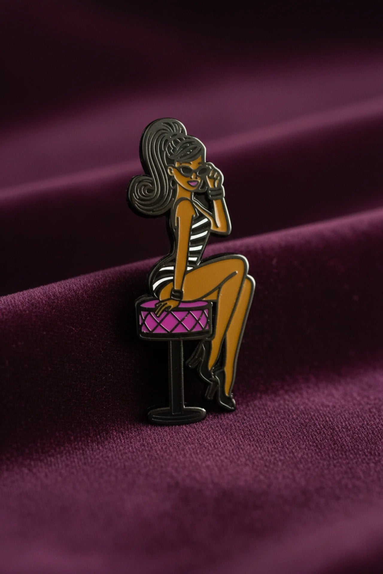 Shop our 1-inch minimalist Black doll pin with sunglasses. Premium enamel lapel pin featuring a rubber clutch. Elevate your everyday style today.